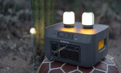 A high-quality portable power station charging devices on the tailgate of a camping truck.