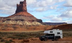An overlanding truck driving on the famous slickrock trails of Moab, Utah.