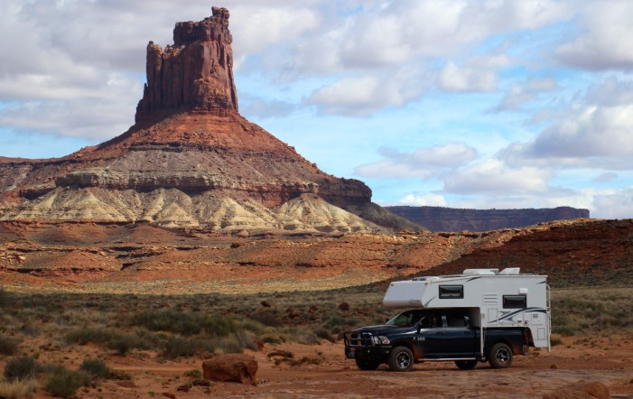 An overlanding truck driving on the famous slickrock trails of Moab, Utah.